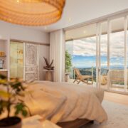 The Retreat Costa Rica’s new Santosha Clubhouse featuring rustic wood furnishings, Indigenous relics, and lush greenery.